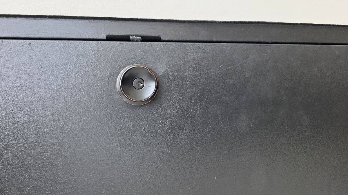 Smartwave M8 smart deadbolt — keyway detail on a painted steel door